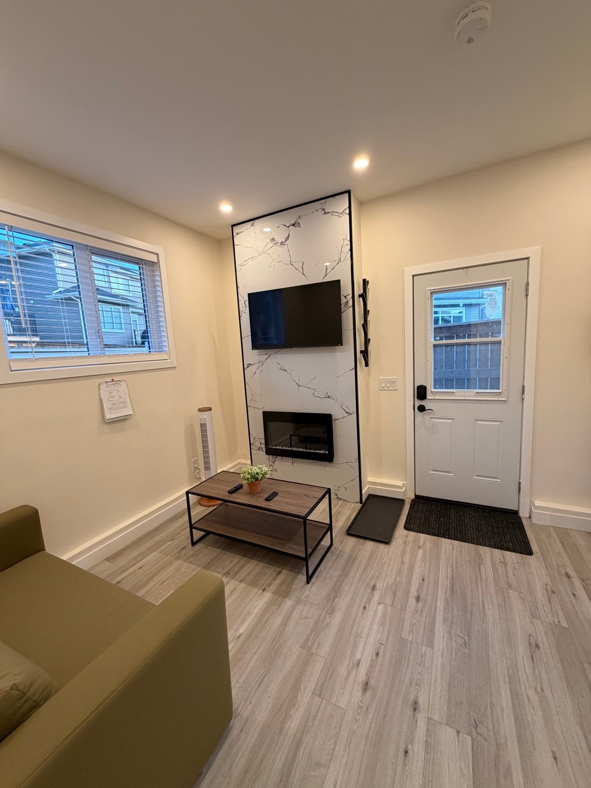Living room entrance with TV and electric fireplace