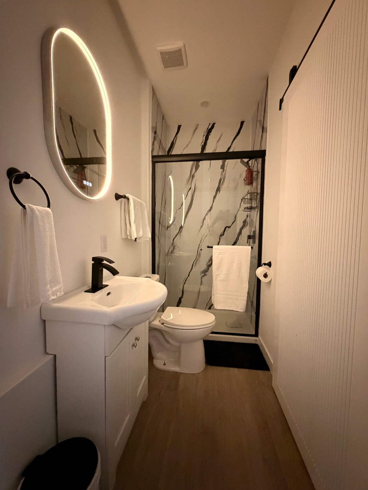 Bathroom with glass shower and LED mirror